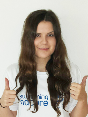 Head‑and‑shoulders portrait of swimming instructor Lauren in a Swimming Nature T‑shirt, smiling.
