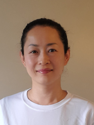 Head‑and‑shoulders portrait of swimming instructor Haruna in a Swimming Nature T‑shirt, smiling.