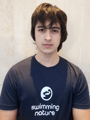Head‑and‑shoulders portrait of swimming instructor Ivan in a Swimming Nature T‑shirt, smiling.