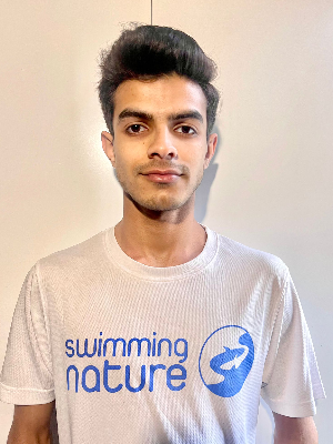 Head‑and‑shoulders portrait of swimming instructor Abdul Wasey in a Swimming Nature T‑shirt, smiling.