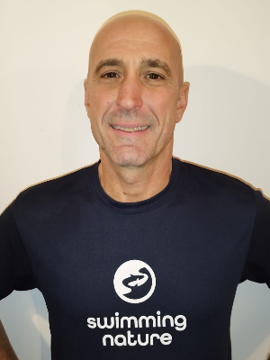 Head‑and‑shoulders portrait of swimming instructor Federico in a Swimming Nature T‑shirt, smiling.