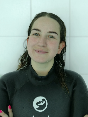 Head‑and‑shoulders portrait of swimming instructor Mariia in a Swimming Nature T‑shirt, smiling.