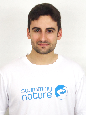 Head‑and‑shoulders portrait of swimming instructor Mario in a Swimming Nature T‑shirt, smiling.